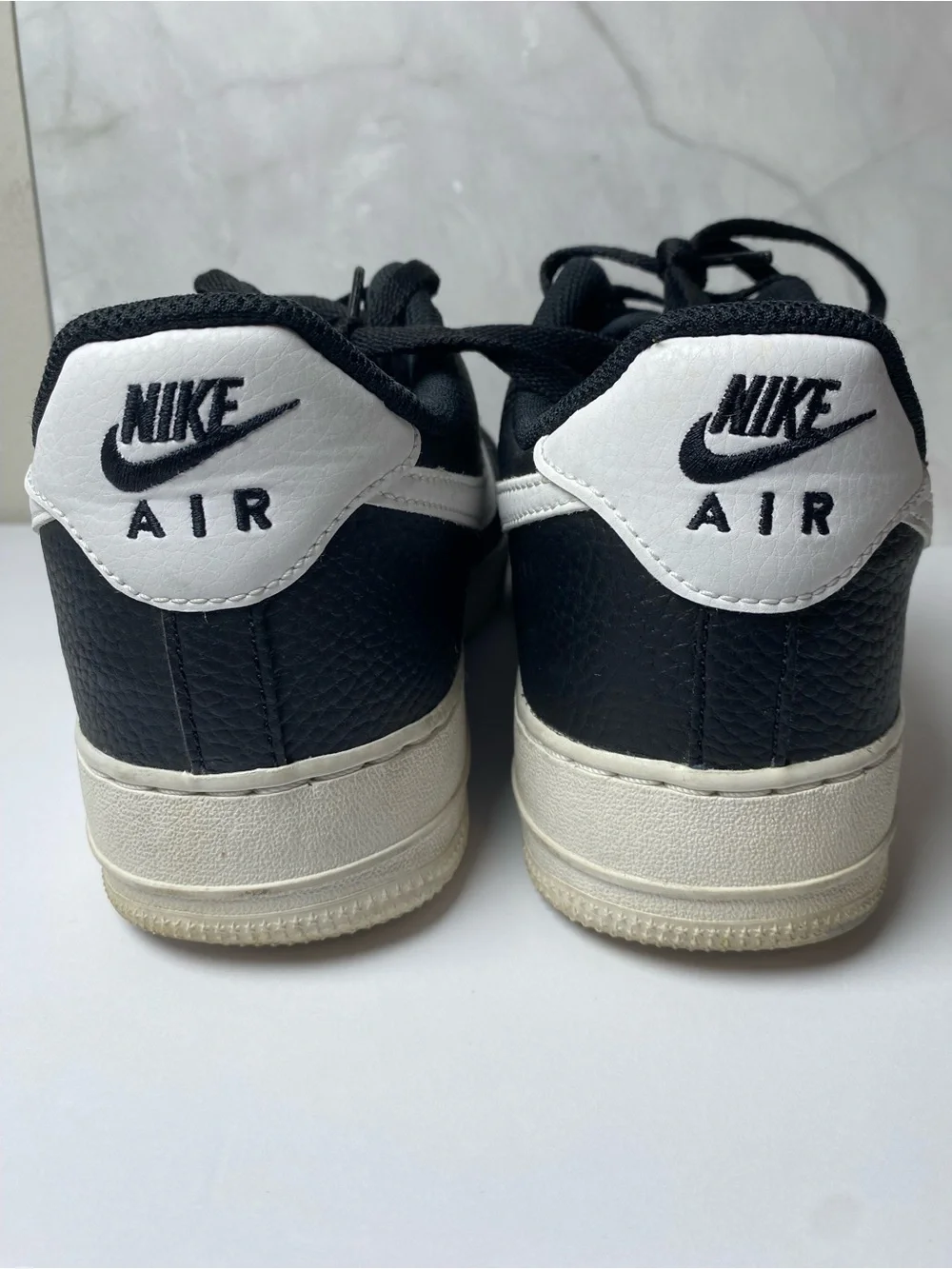 Nike Black Leather Sneakers with White Swoosh.